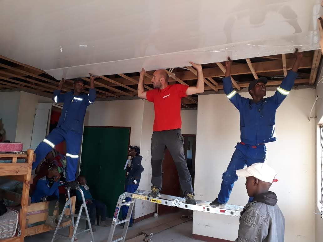 Photo of Fellows working on installation of ceiling at God's Love Centre Orphanage